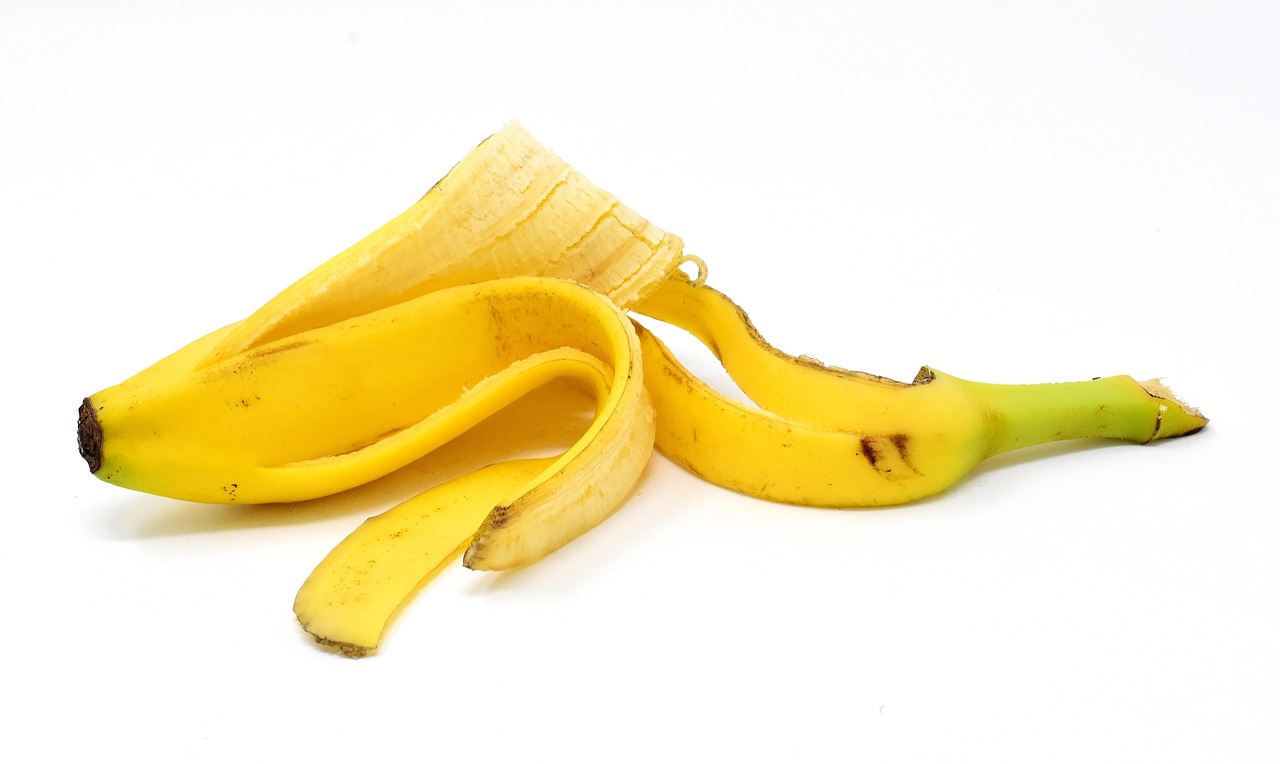 Buccia di banana nel vaso di fiori, evidenziando gli effetti sul terreno e sulle piante circostanti.